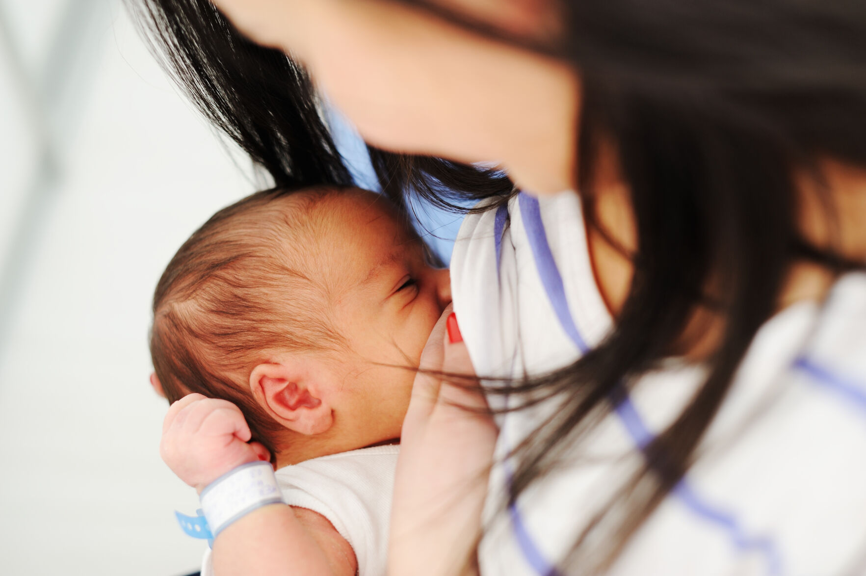 Mother breastfeeding newborn baby